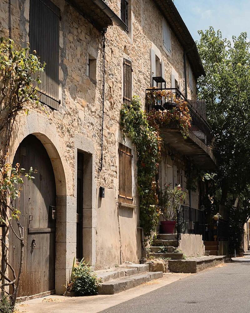 A traditional stone house street in a charming French village near Les Castels luxury campsite in Ardeche.